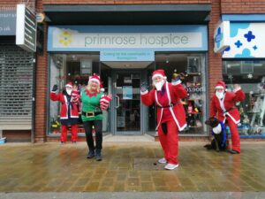 Fundraising team outside Primrose Hospice shop during the Santa Fun Run
